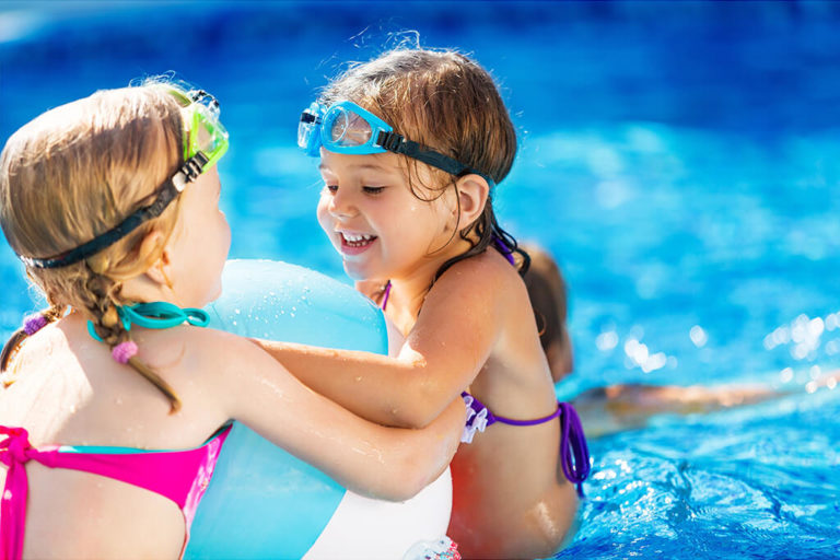 Two neighborhood children playing in the community swimming pool